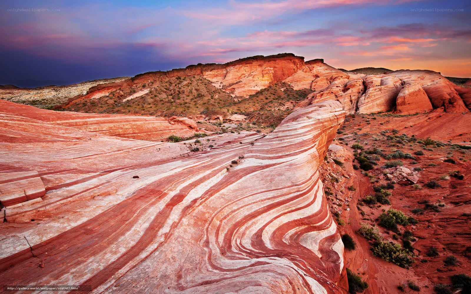 Striated rock formations at sunset