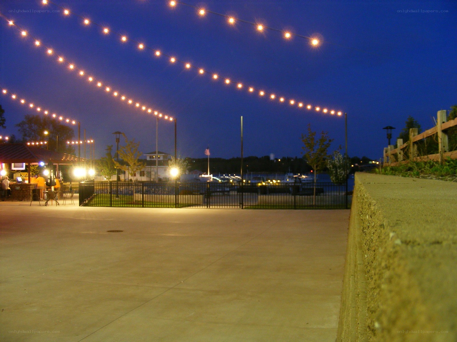 String lights over a waterfront patio