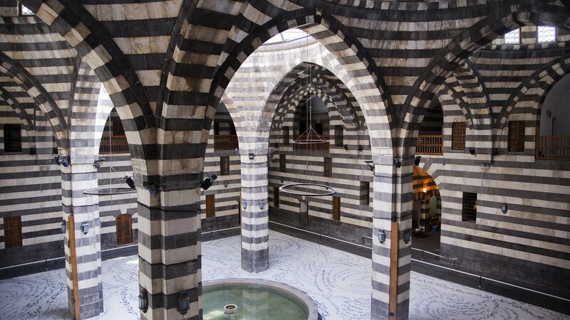 Striped arches in a historic courtyard