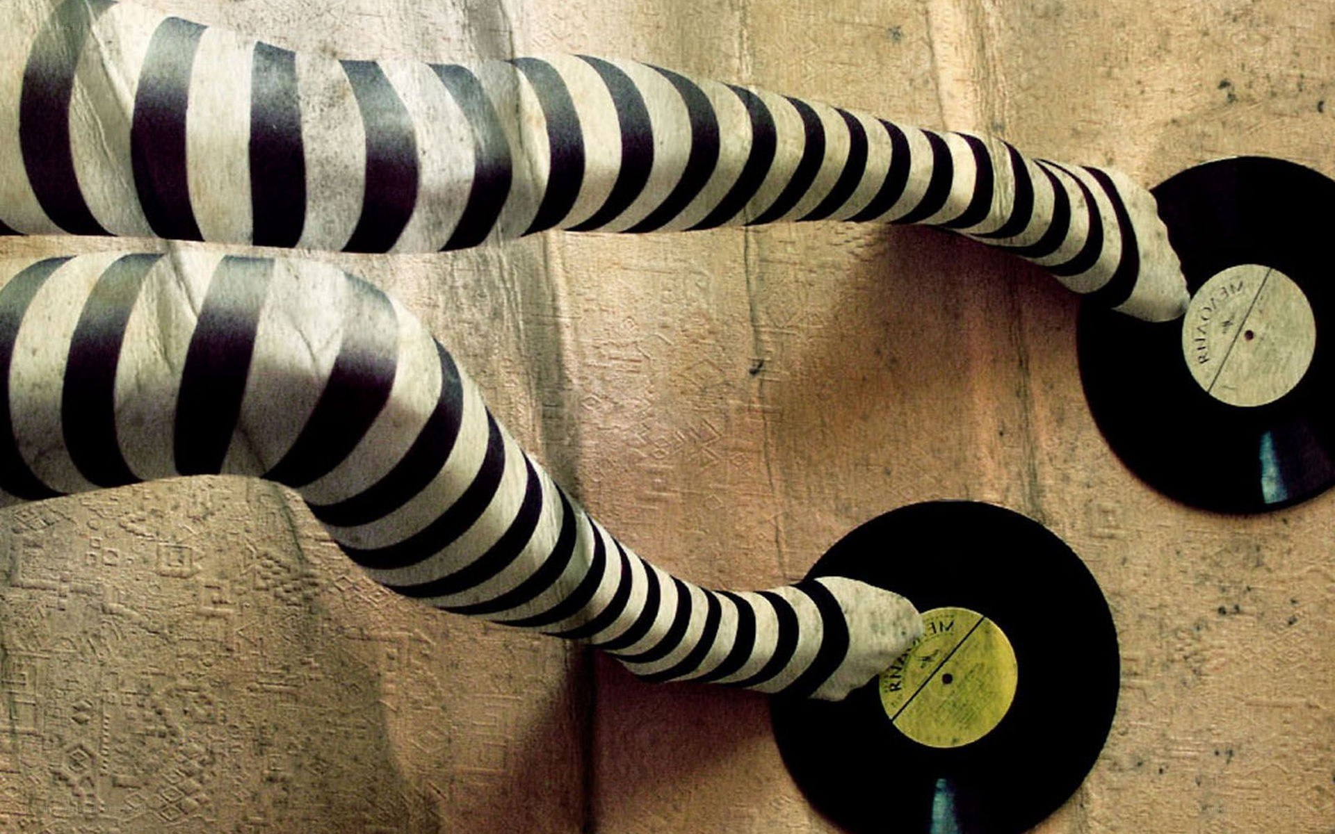 striped arms holding records