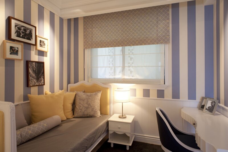 striped bedroom with yellow accents