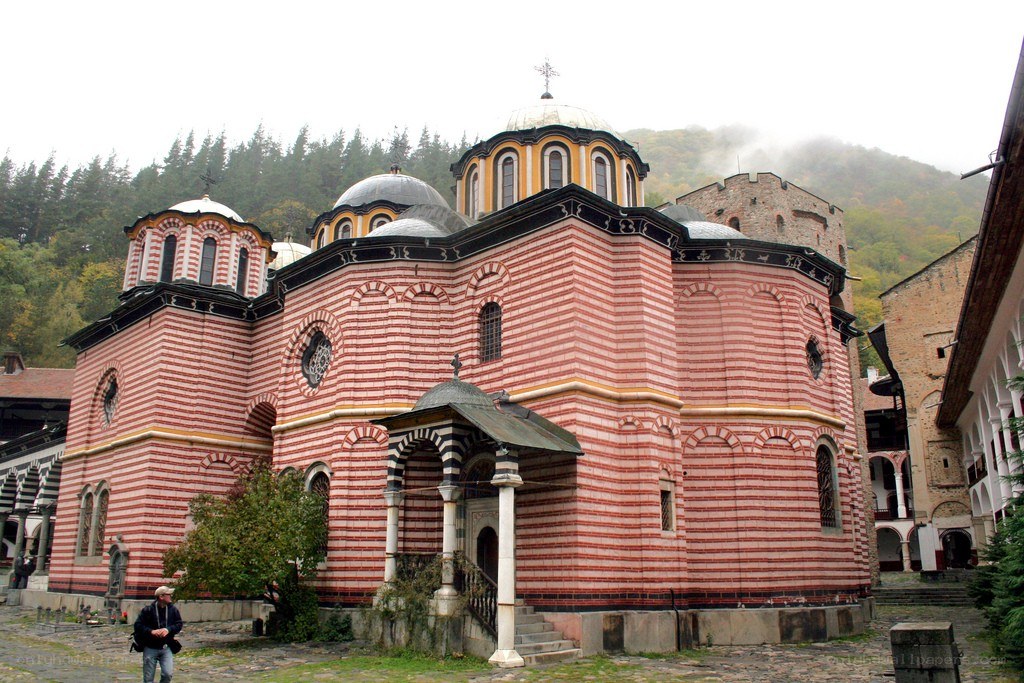Striped church in mountain valley