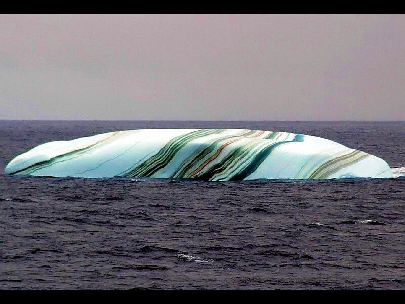 Striped iceberg in ocean