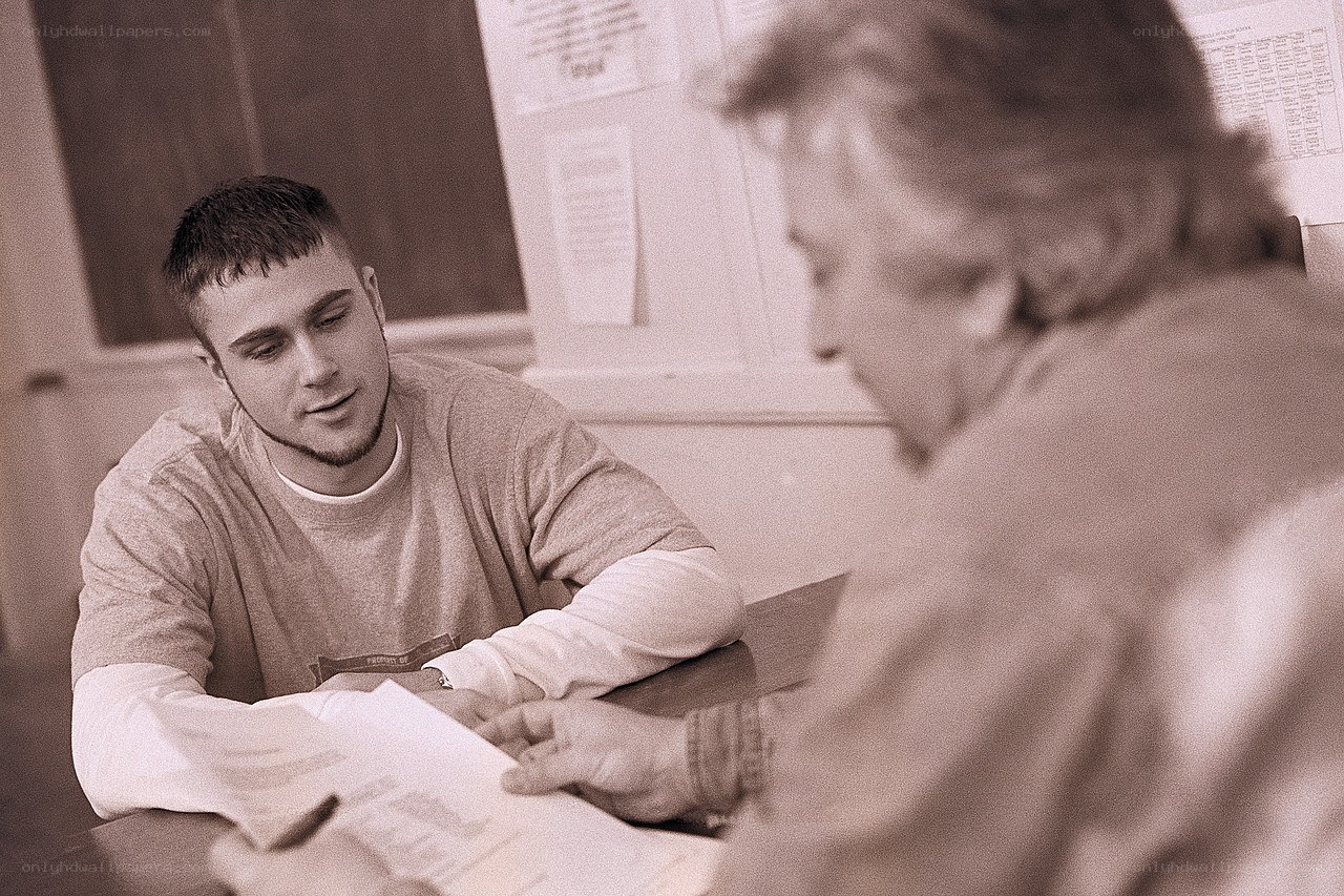 Student and teacher discussing papers
