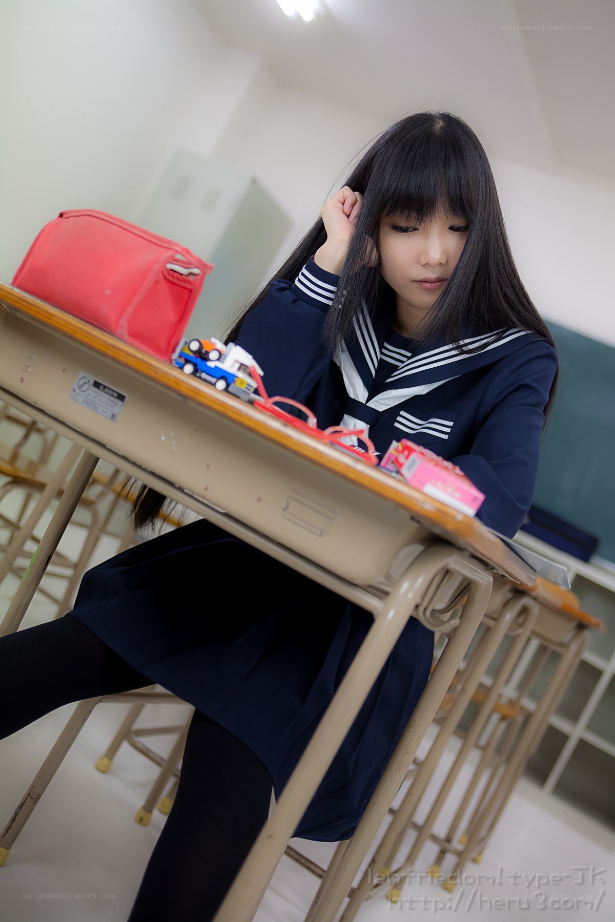 student at a desk in classroom