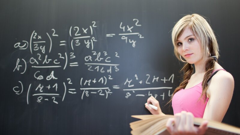 student at blackboard with math