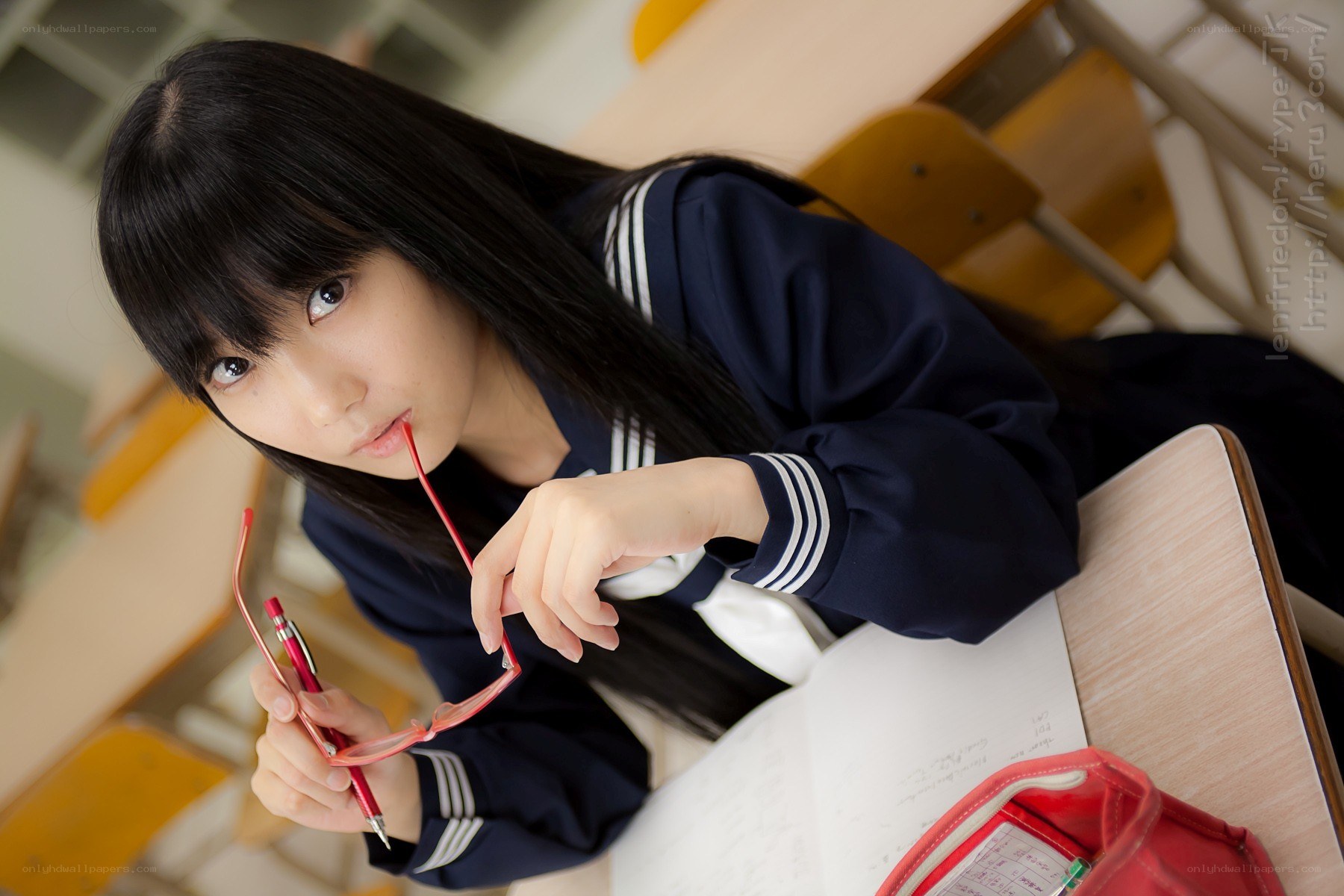 student at desk with glasses