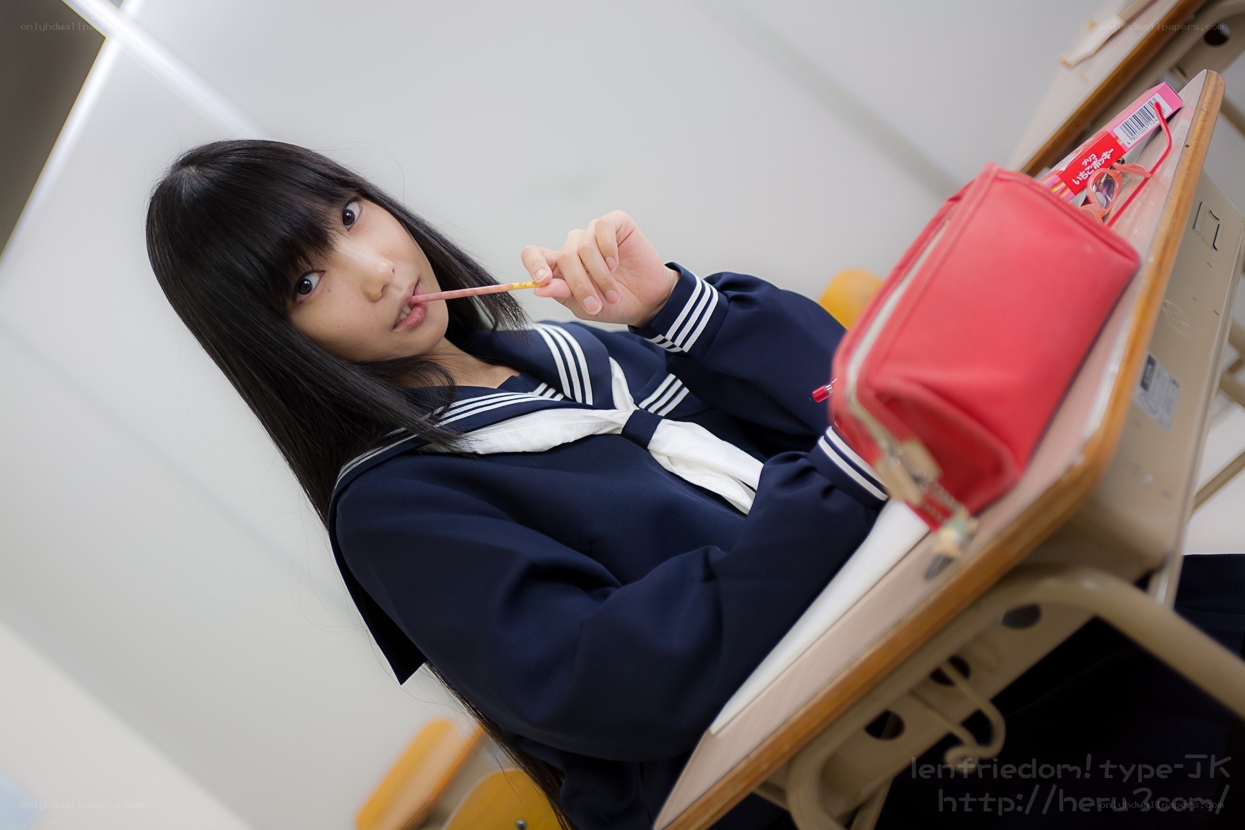 student at desk with pencil
