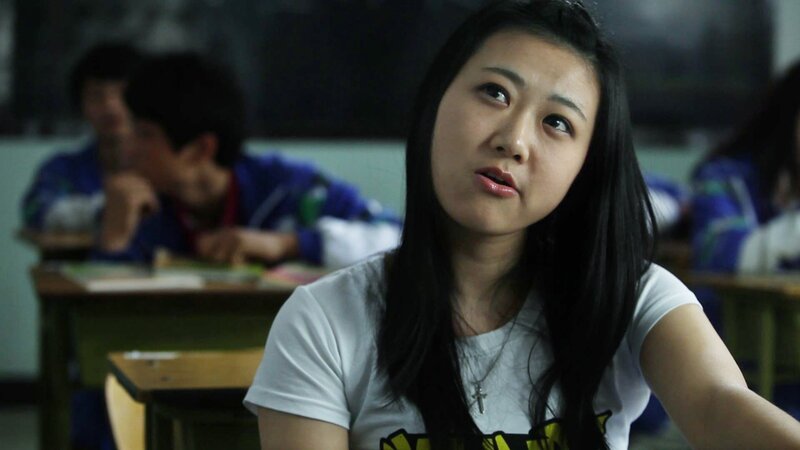 student in classroom looking up