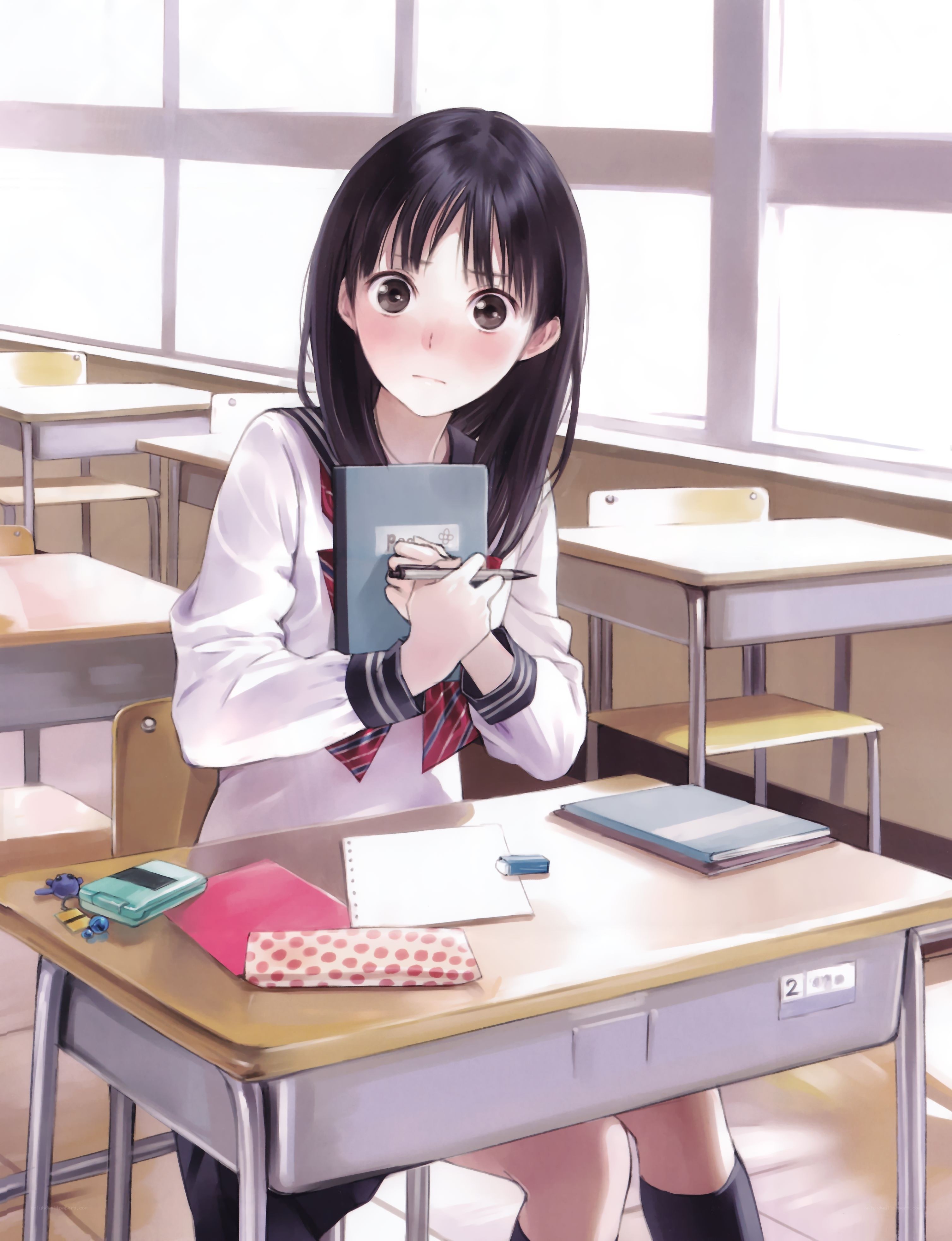 Student in classroom with notebook