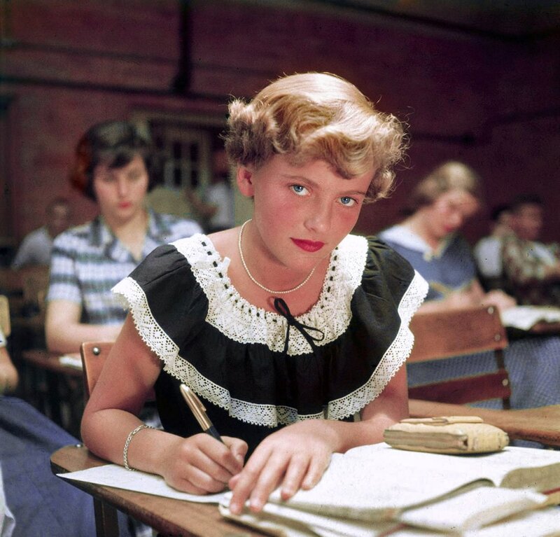 Student in classroom writing