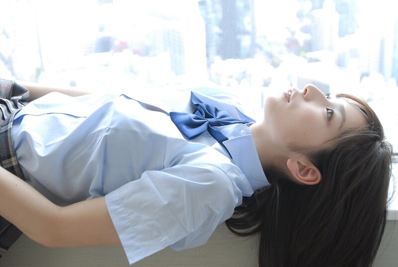 student in uniform lying down