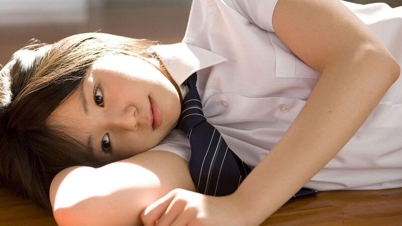 student in uniform lying down