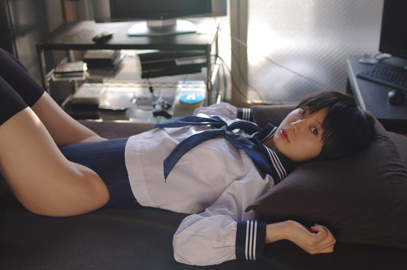 student in uniform lying down