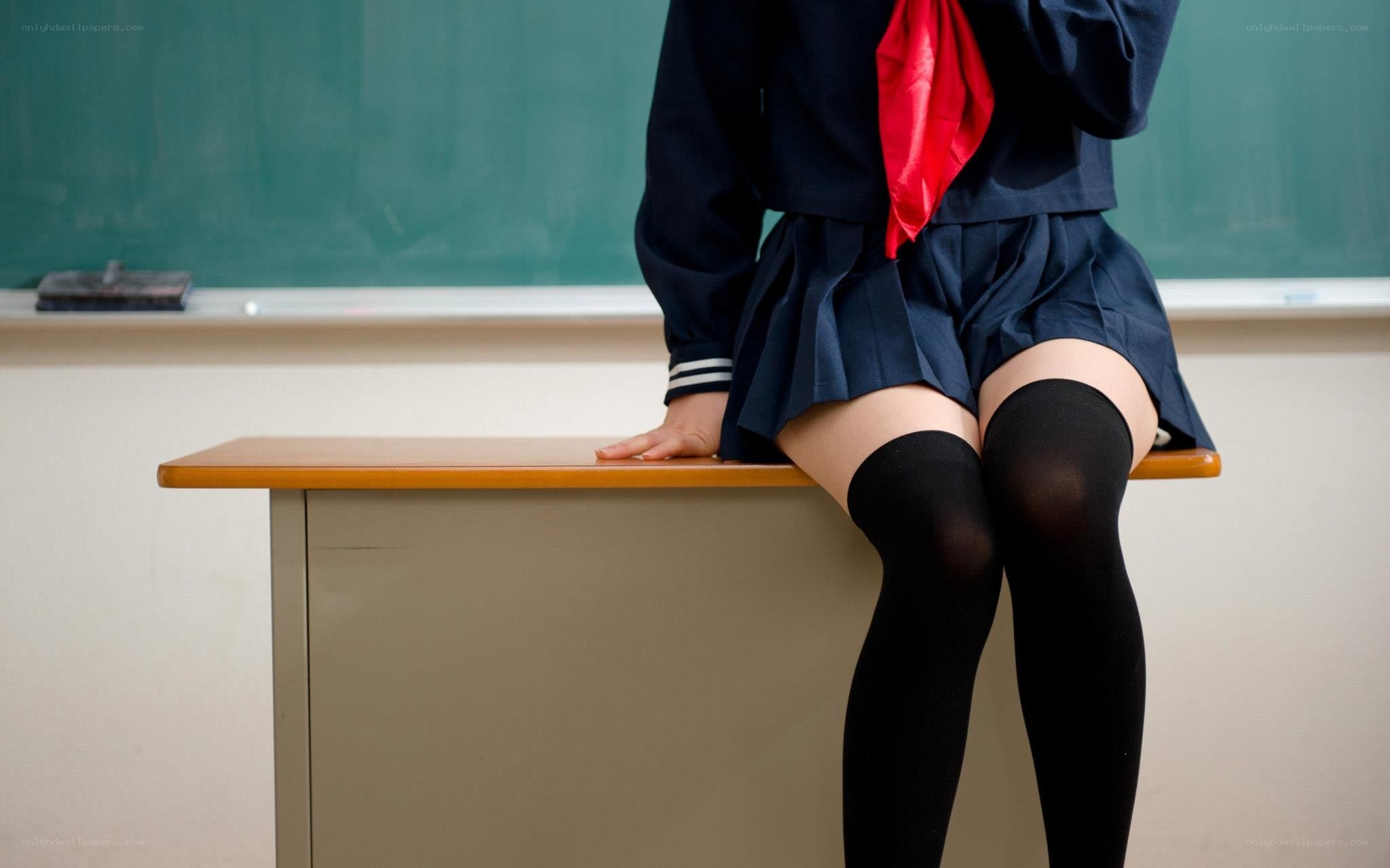 student in uniform on desk