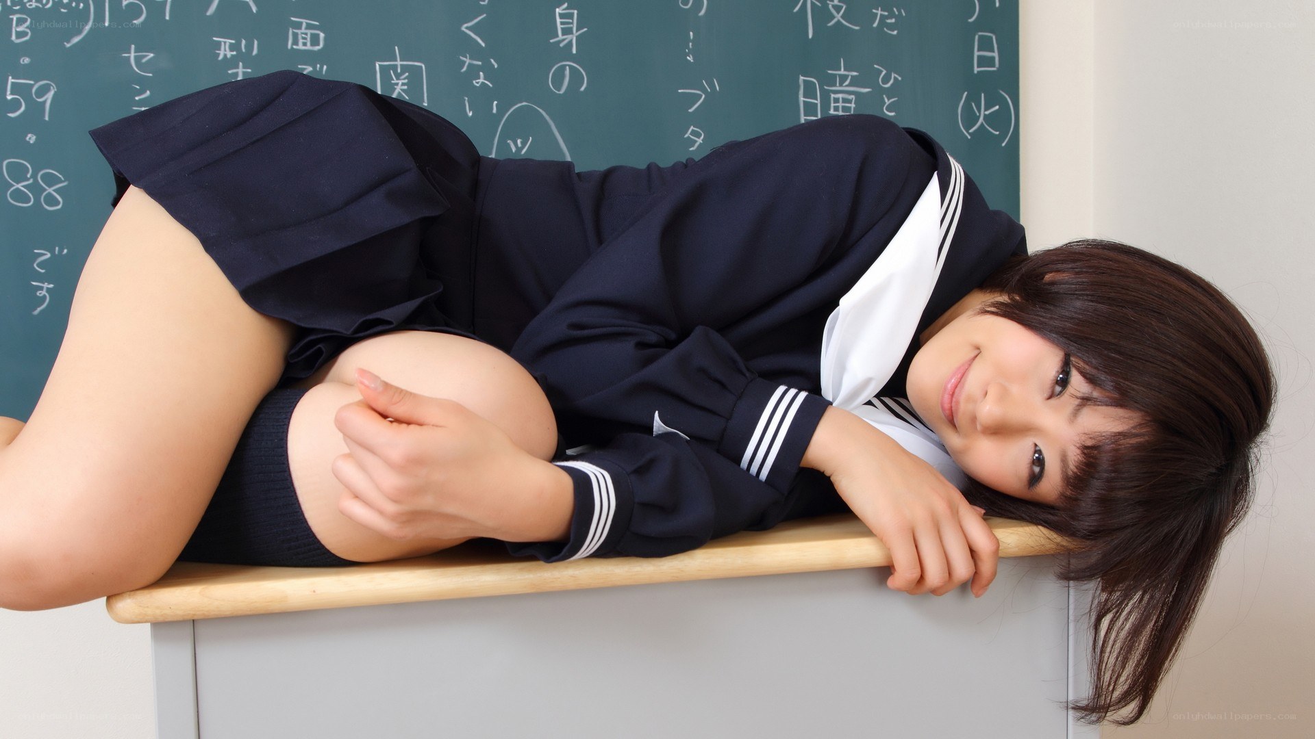 student in uniform on desk