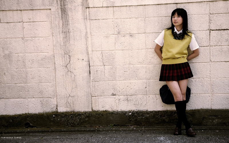 student leaning against wall