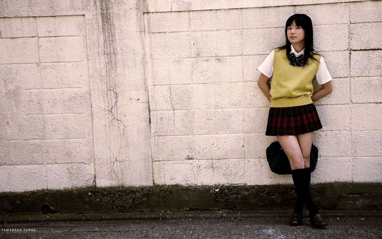 student leaning against wall