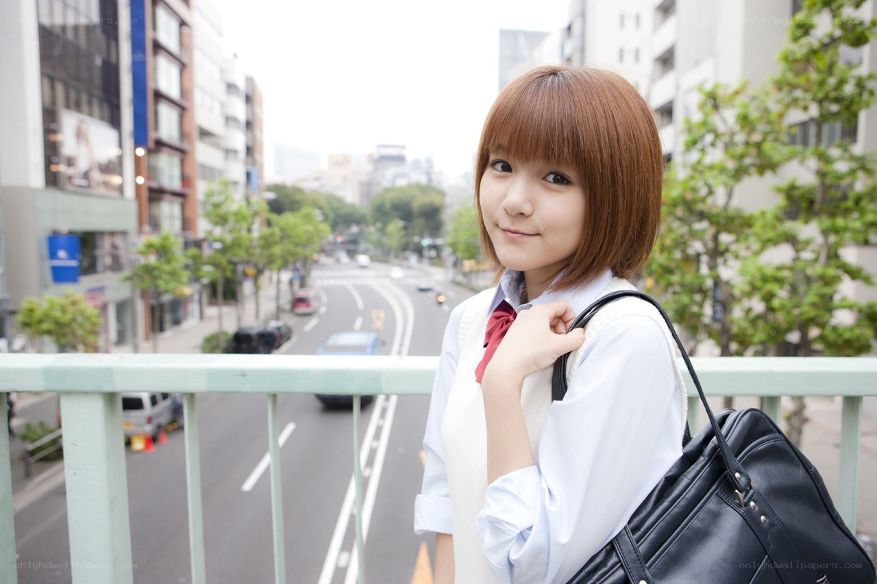 student on a city bridge