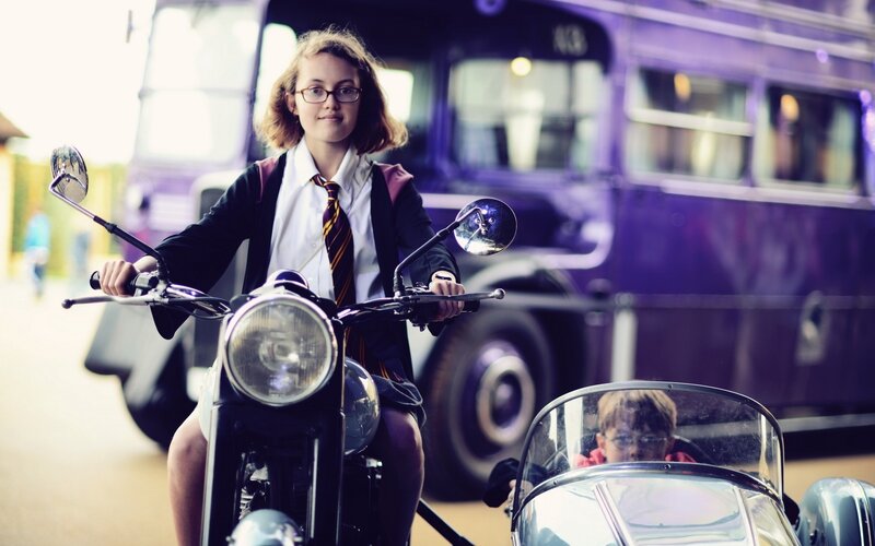 Student on motorcycle with sidecar