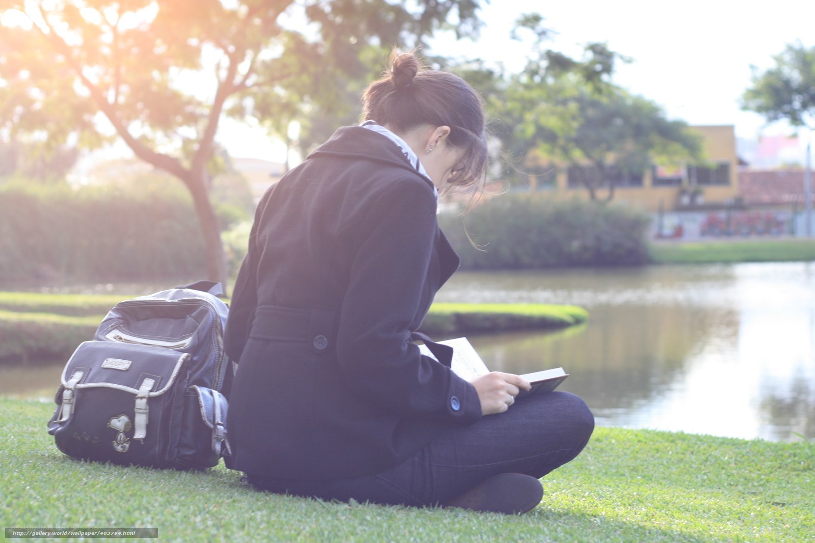 Student reading by the pond