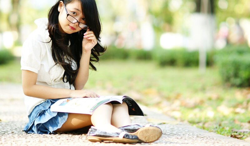 Student reading in park