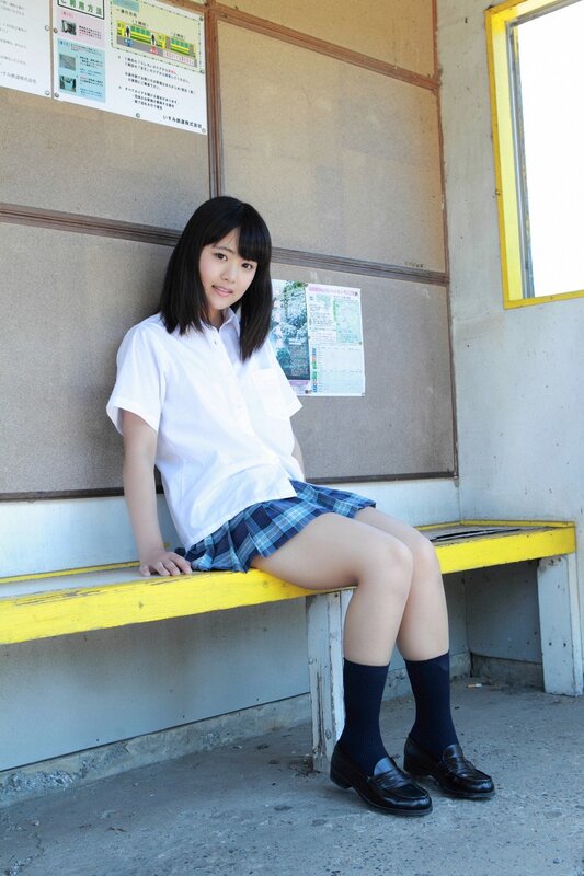 Student sitting at a bus stop