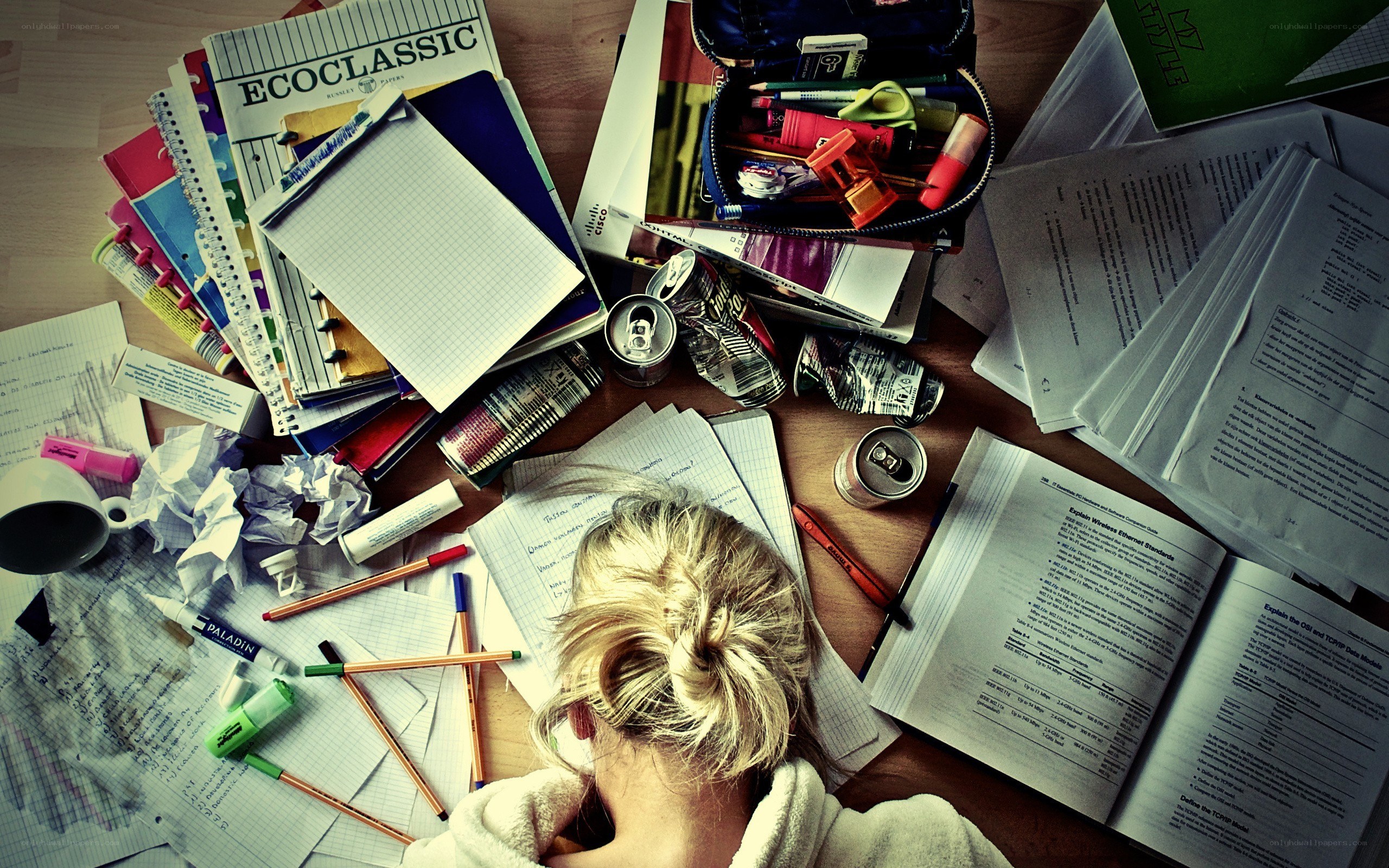 Student studying at a messy desk