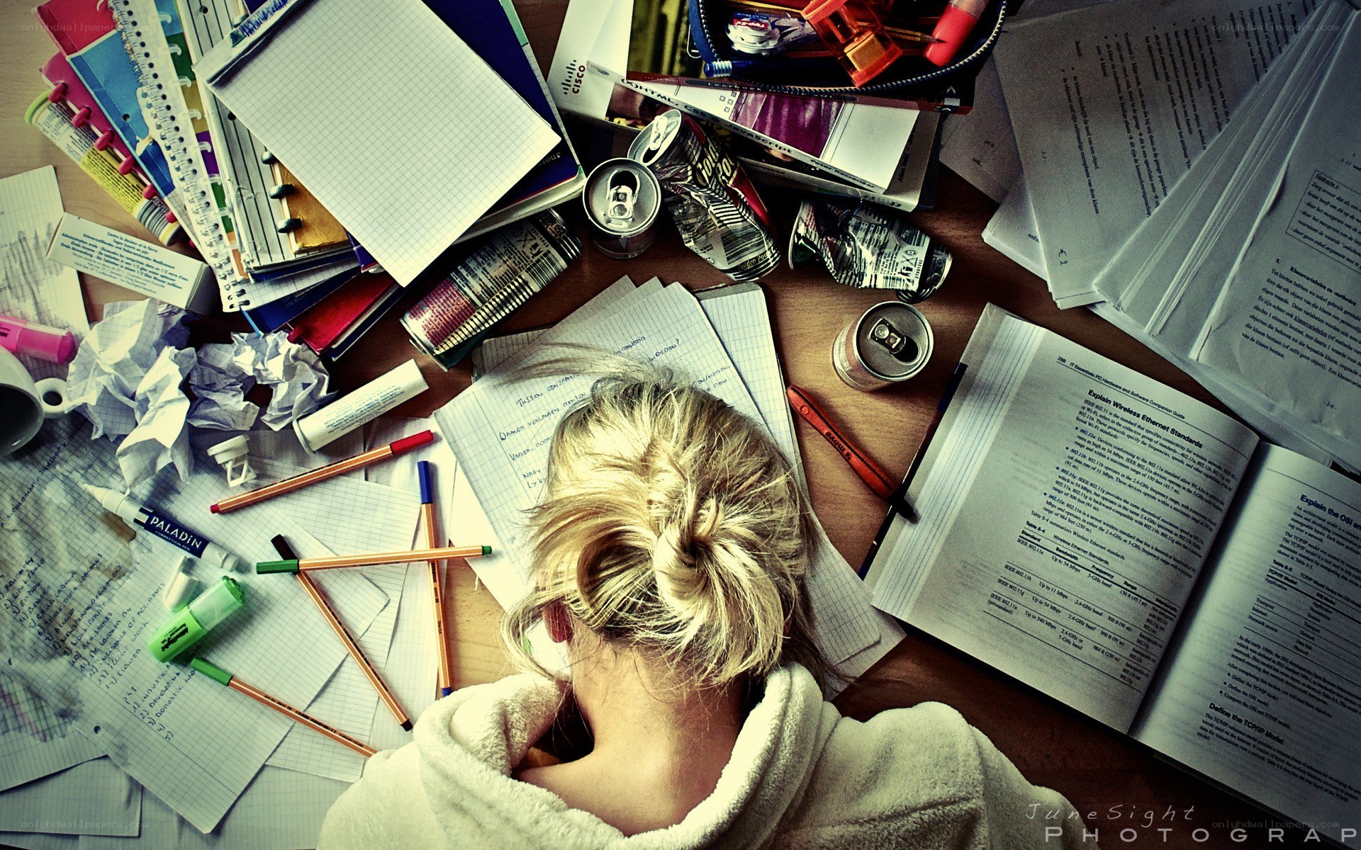 Student studying at a messy desk