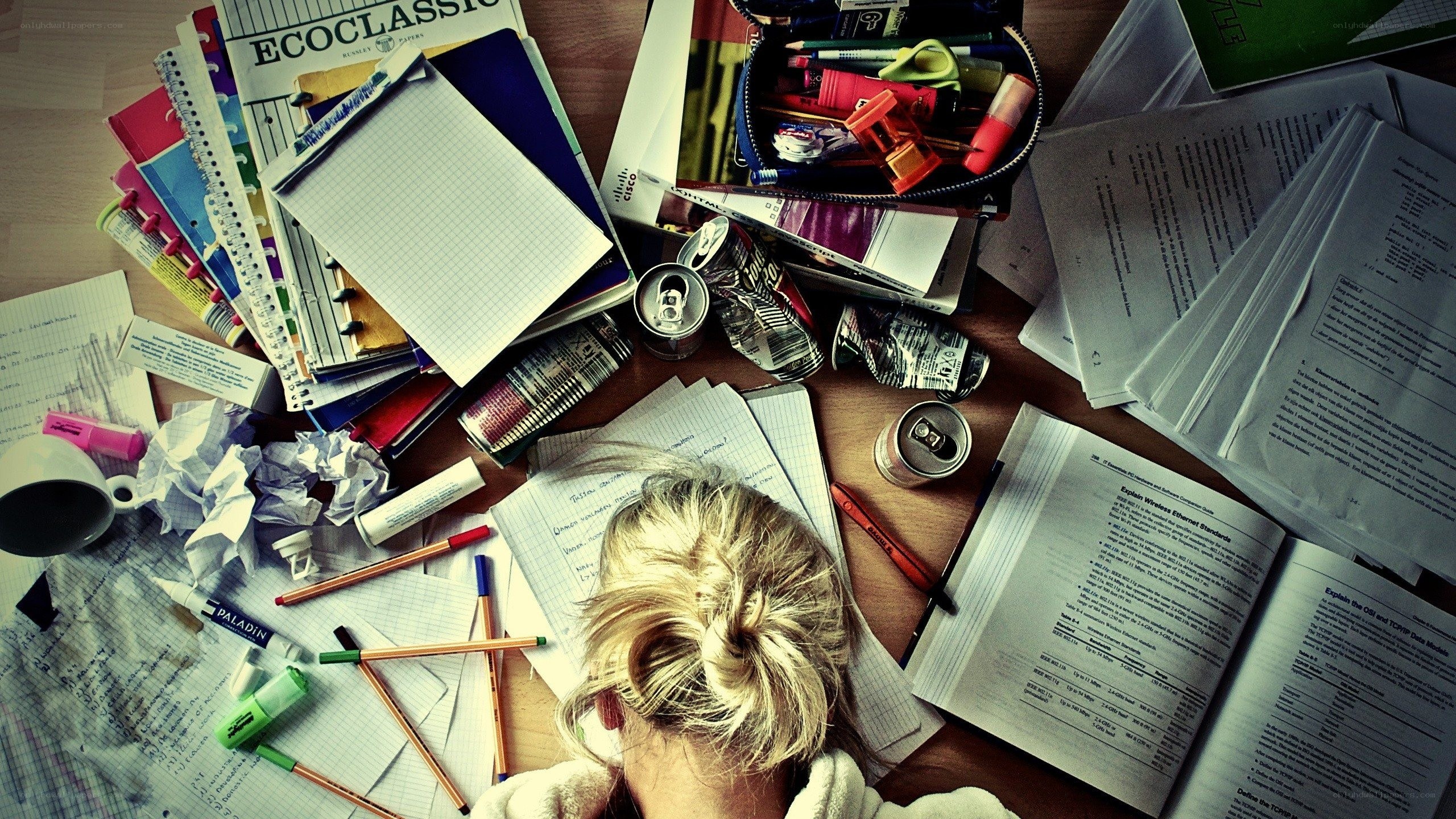Student studying at a messy desk