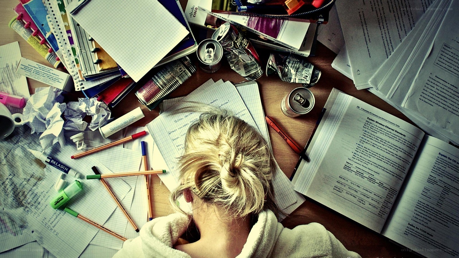 Student studying at a messy desk
