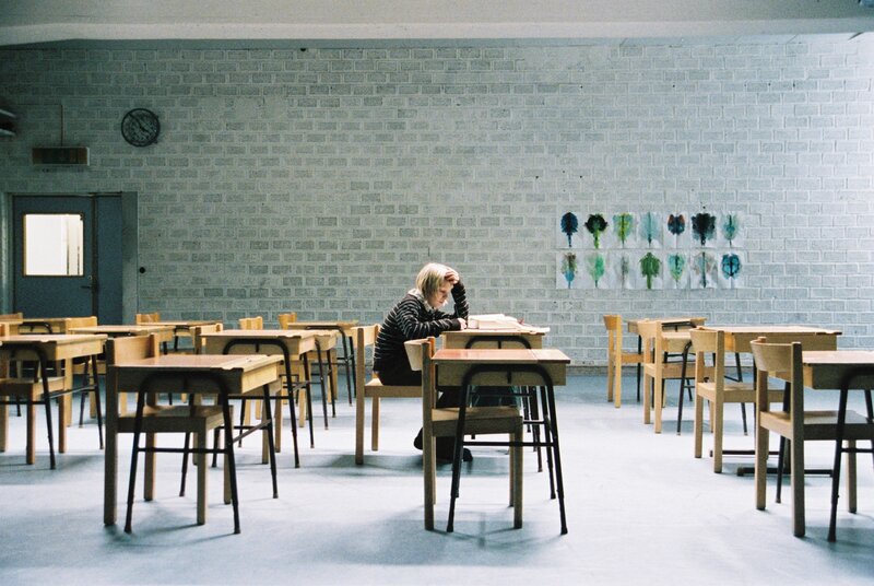Student studying in empty classroom