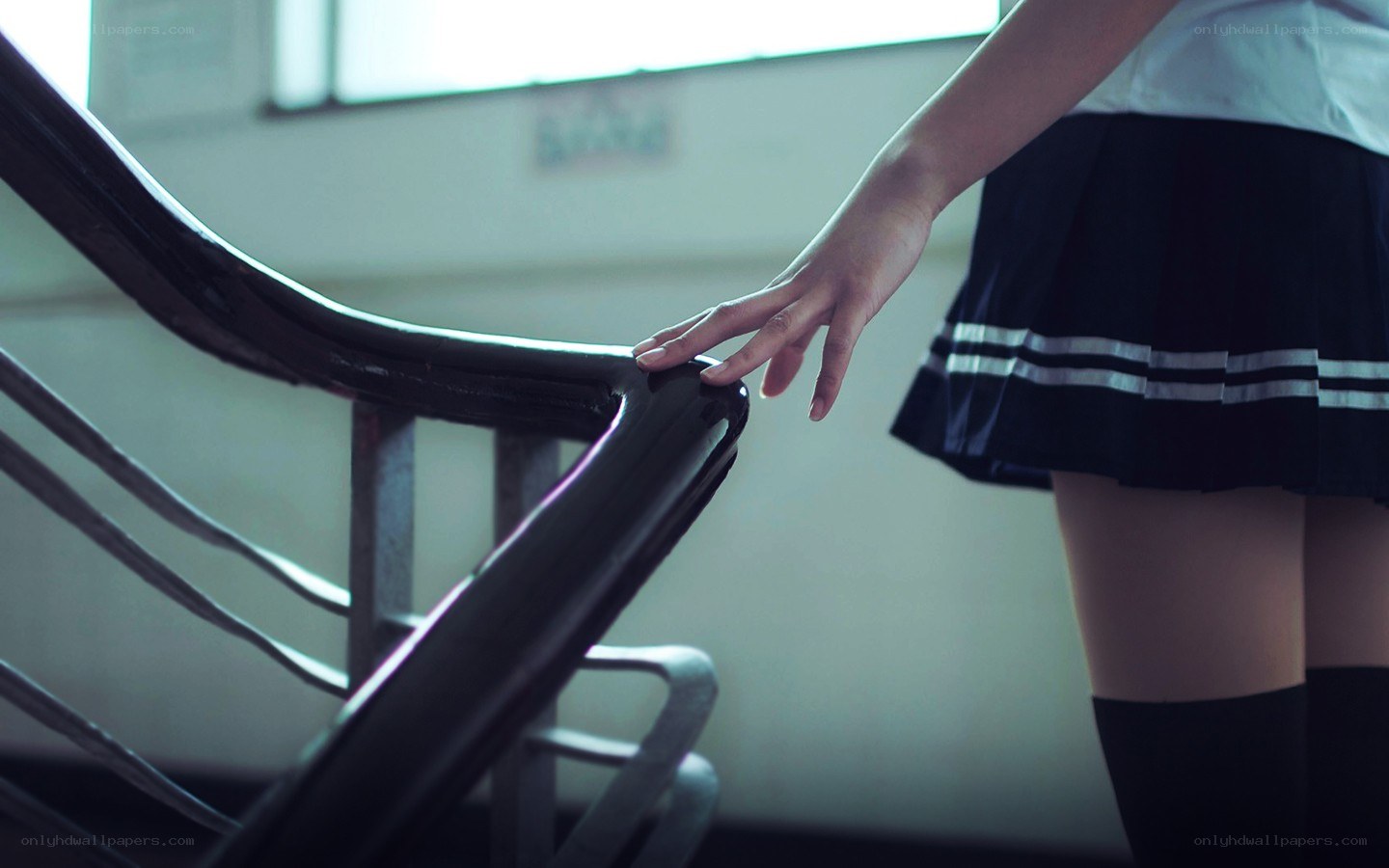 student touching handrail