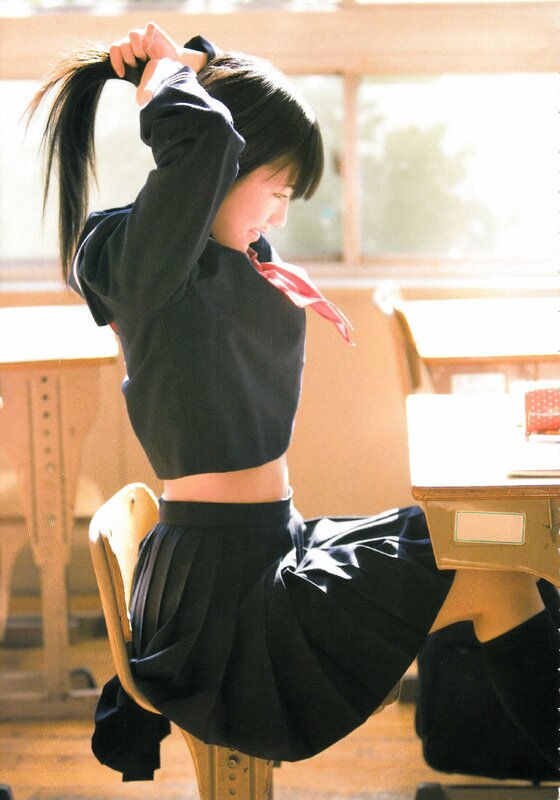 Student tying her hair in a classroom