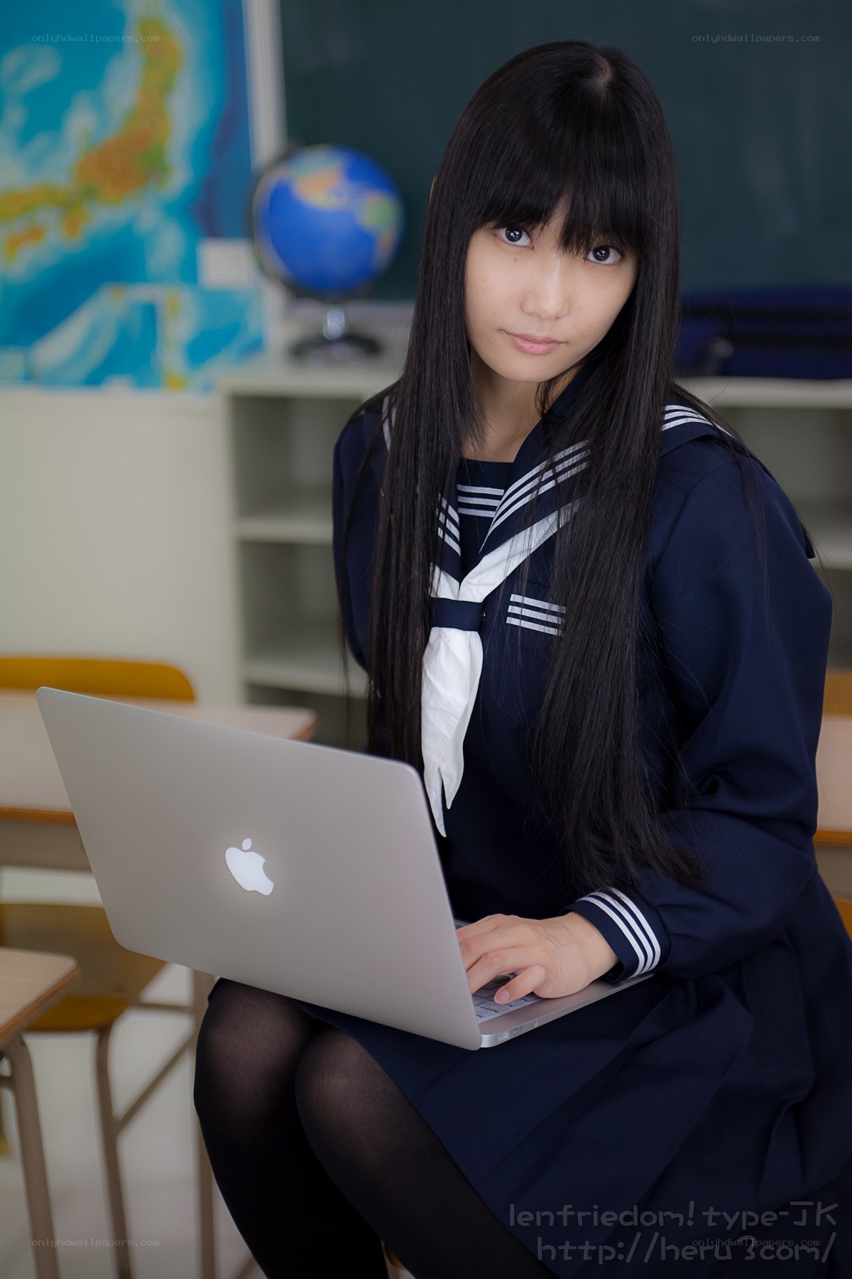 Student using laptop in classroom