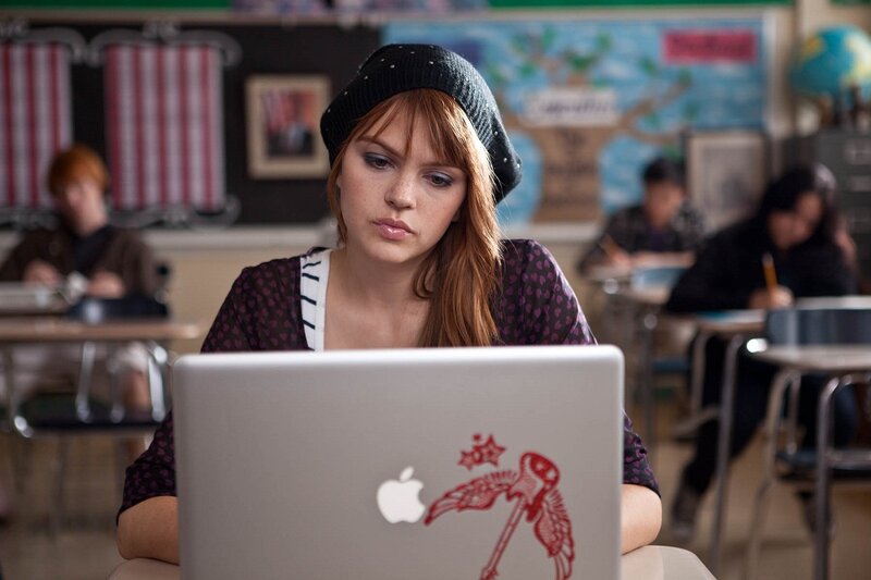 Student using laptop in classroom