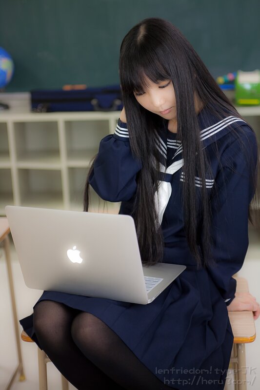 Student using laptop in classroom