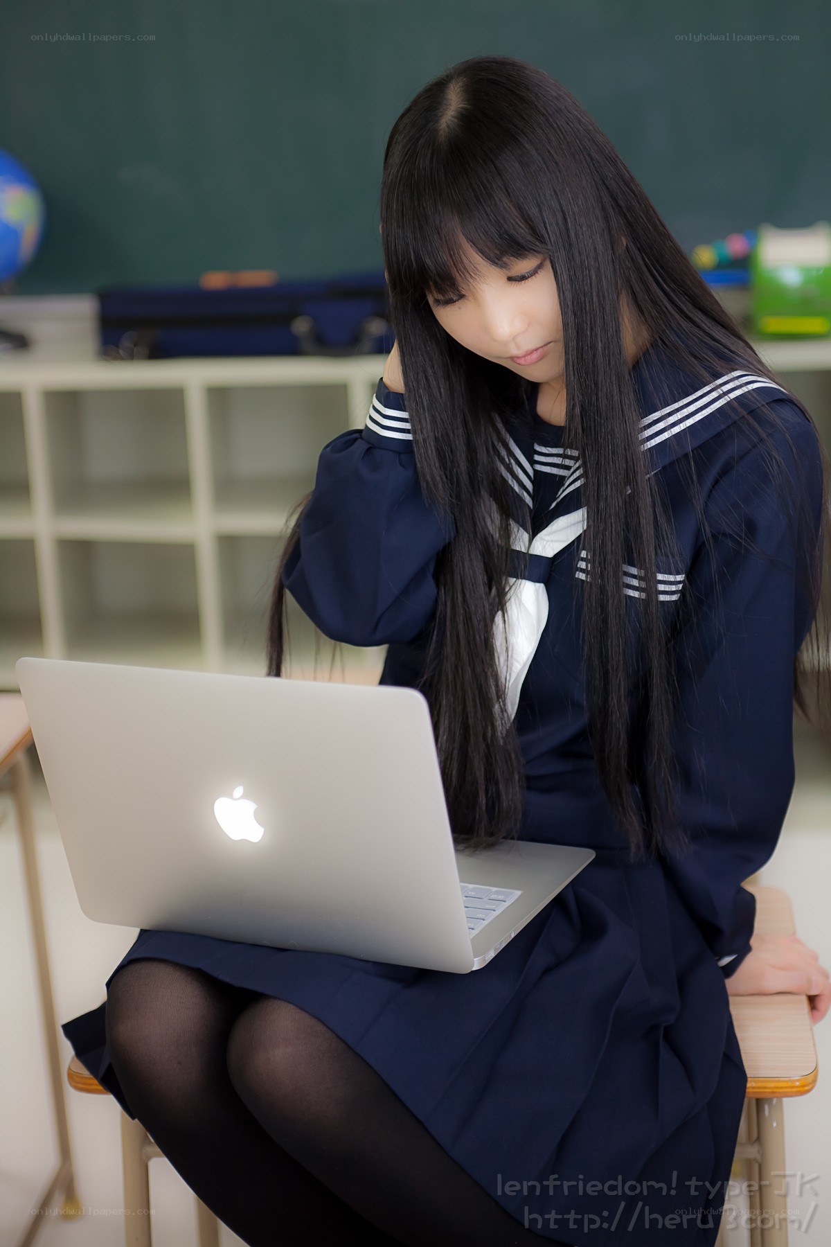 Student using laptop in classroom