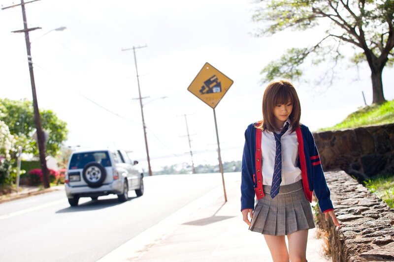 Student walking on sidewalk