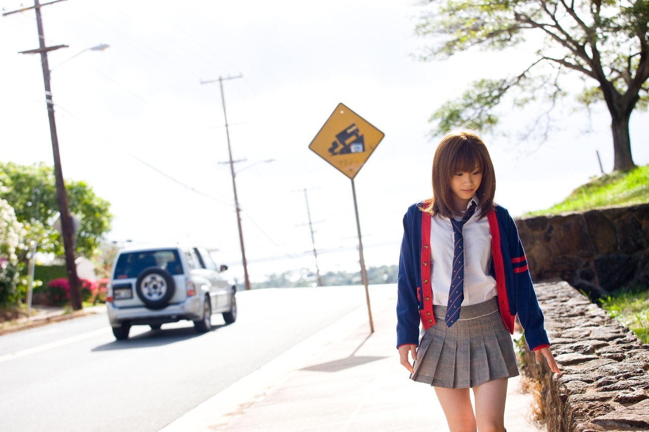 Student walking on sidewalk