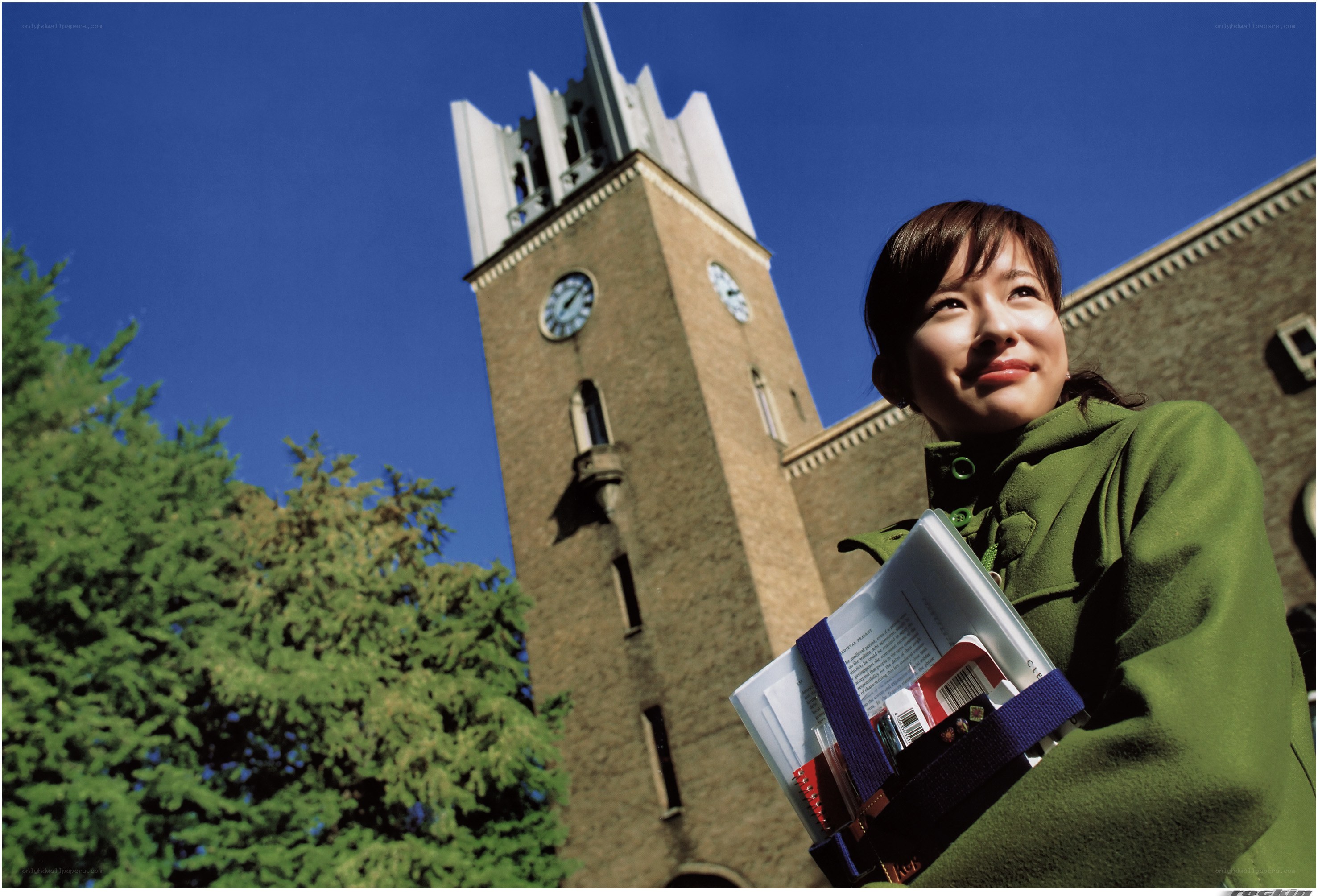 Student with books near clock tower