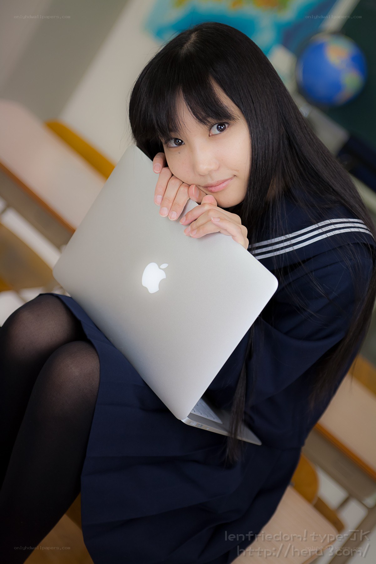 Student with laptop in classroom