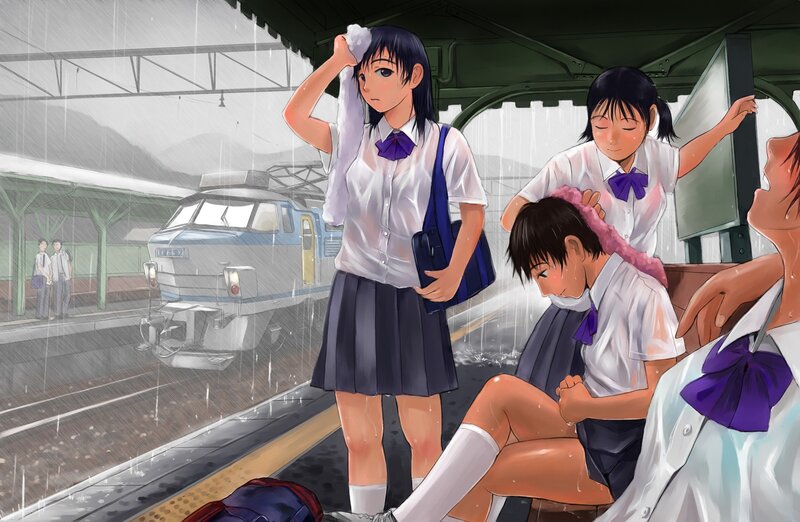 Students at a rainy train station