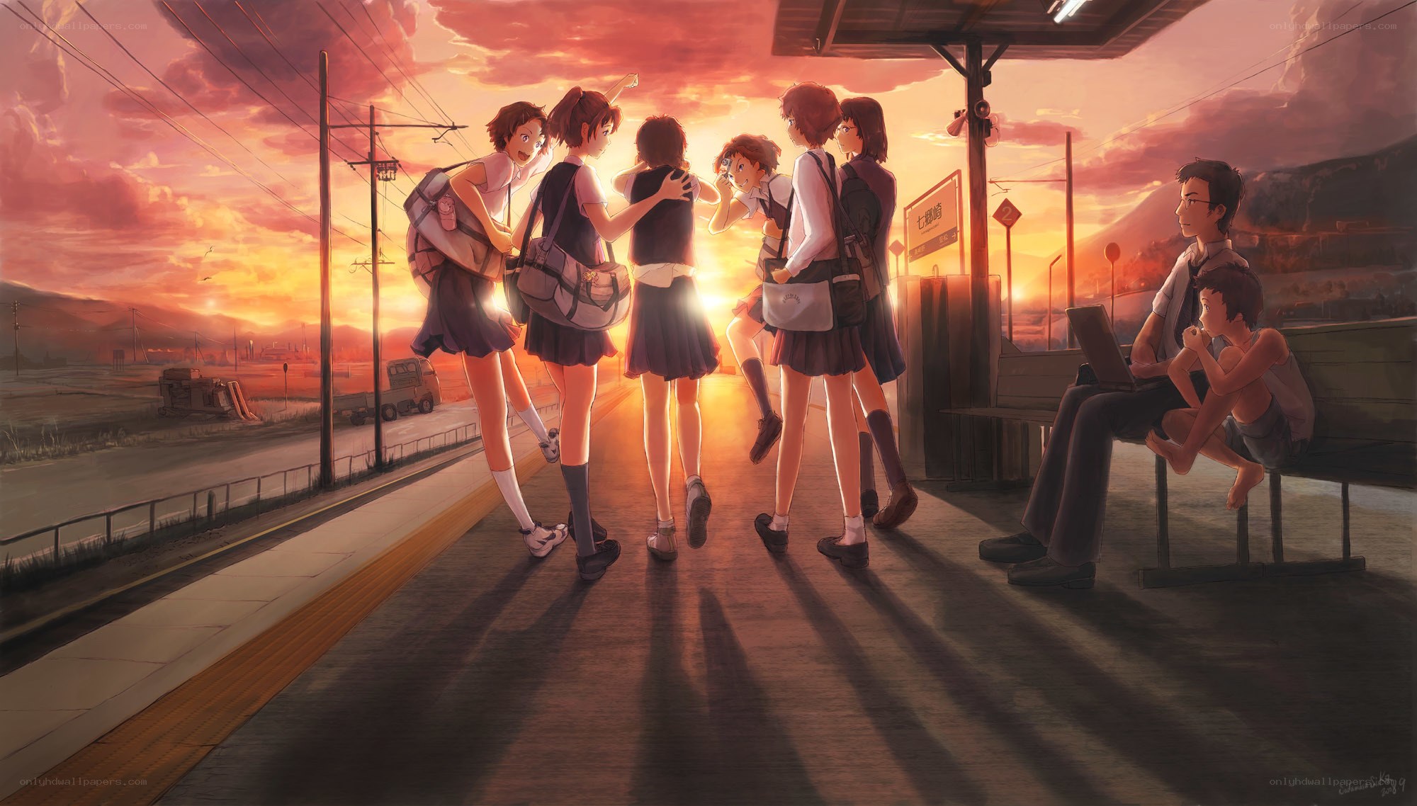 Students at a train station at sunset