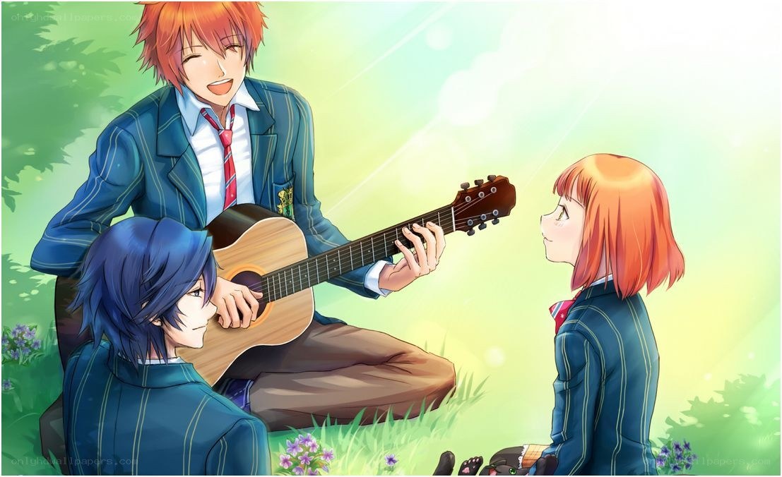 Students playing guitar in a field