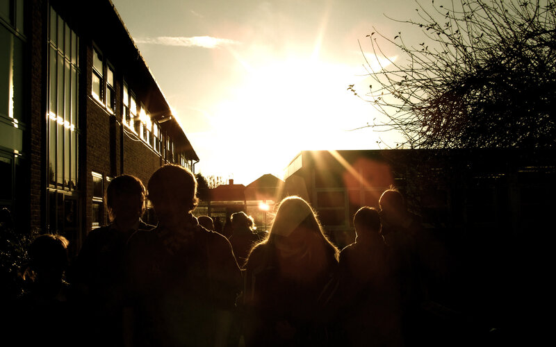 Students silhouetted at sunset