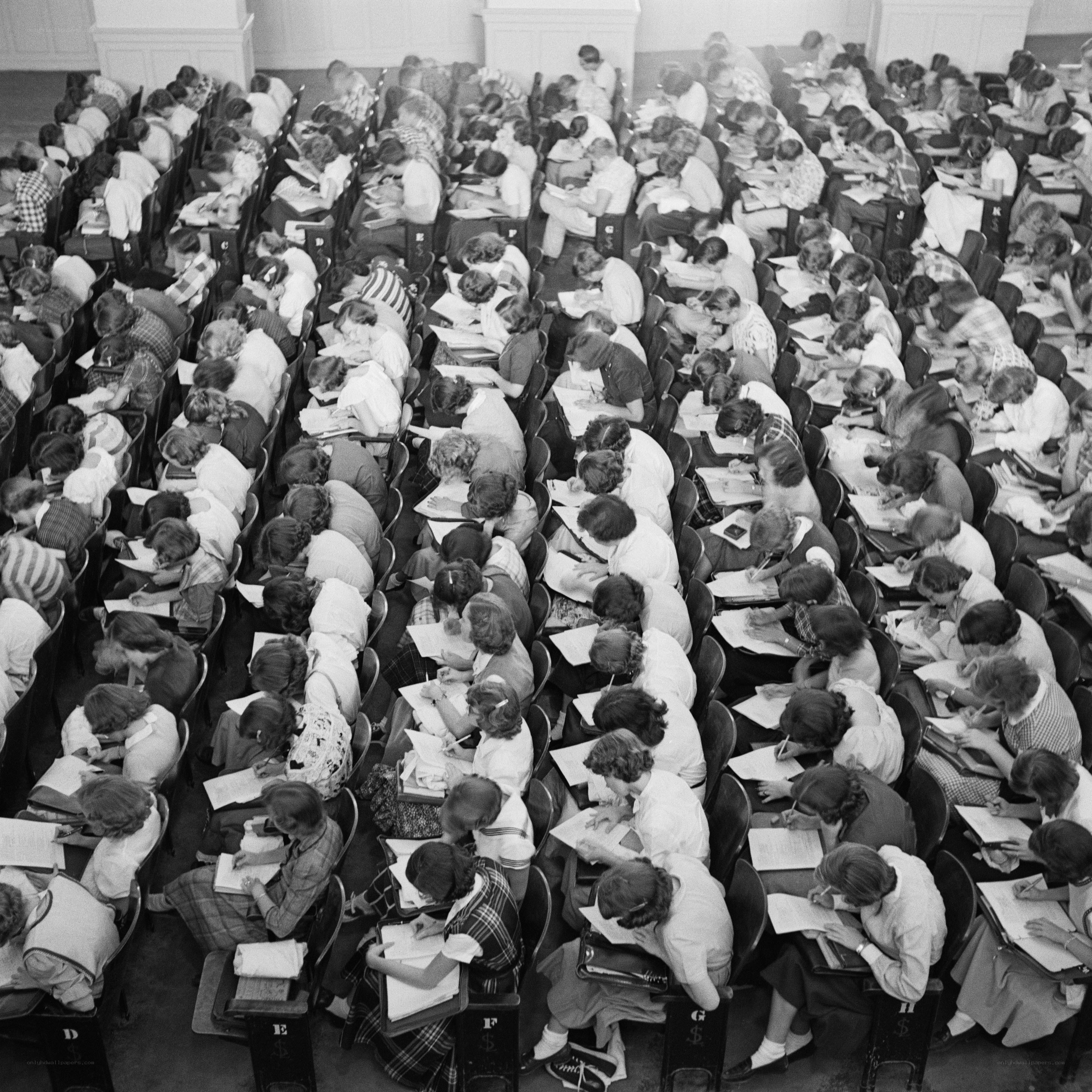 Students taking an exam in a large hall