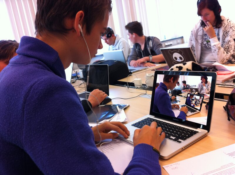 Students working on laptops in classroom