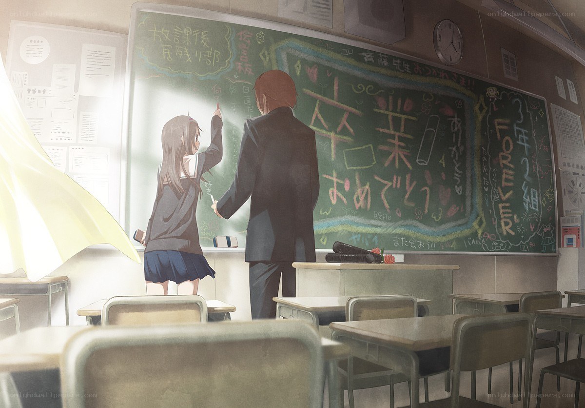 Students writing on a classroom chalkboard