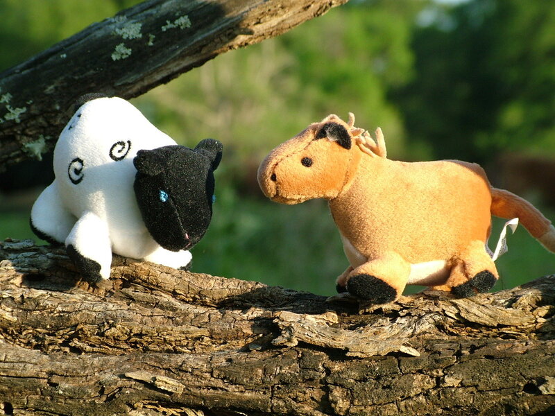 Stuffed animals on a log